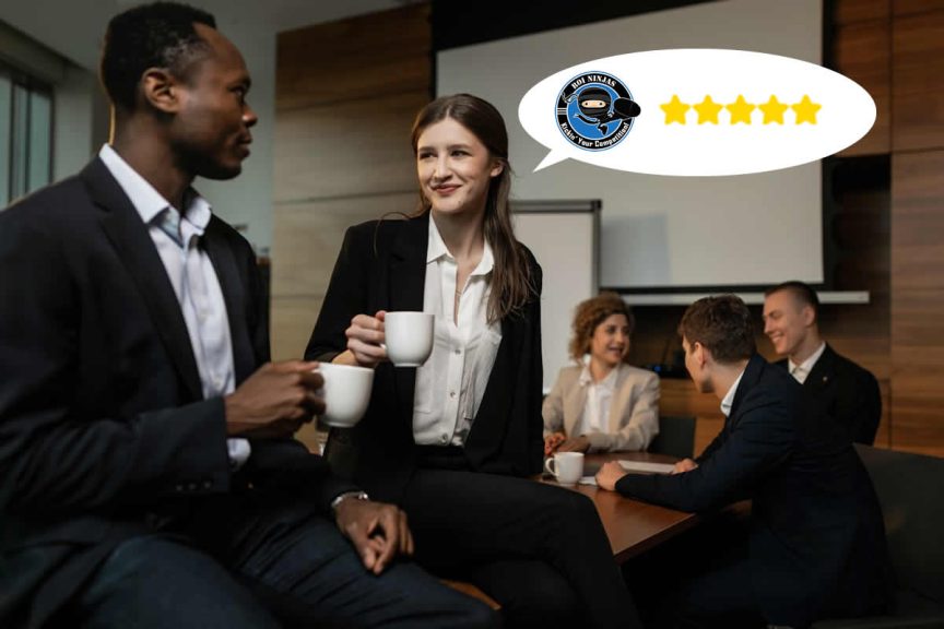 Smiling businesswoman holding a coffee cup with a five-star review speech bubble featuring the ROI Ninjas logo, while colleagues chat around a table.